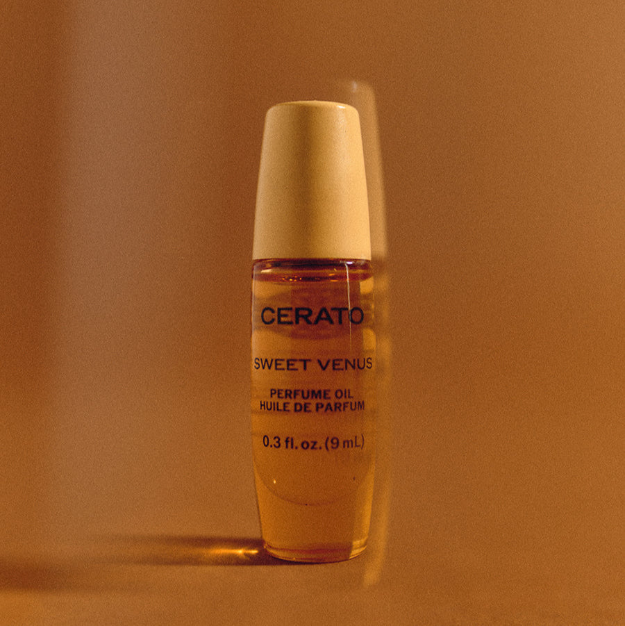 Two bottles of Cerato Sweet Venus perfume oil on a light background