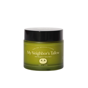 Green jar with black lid labeled 'My Neighbor's Tallow' on a white background