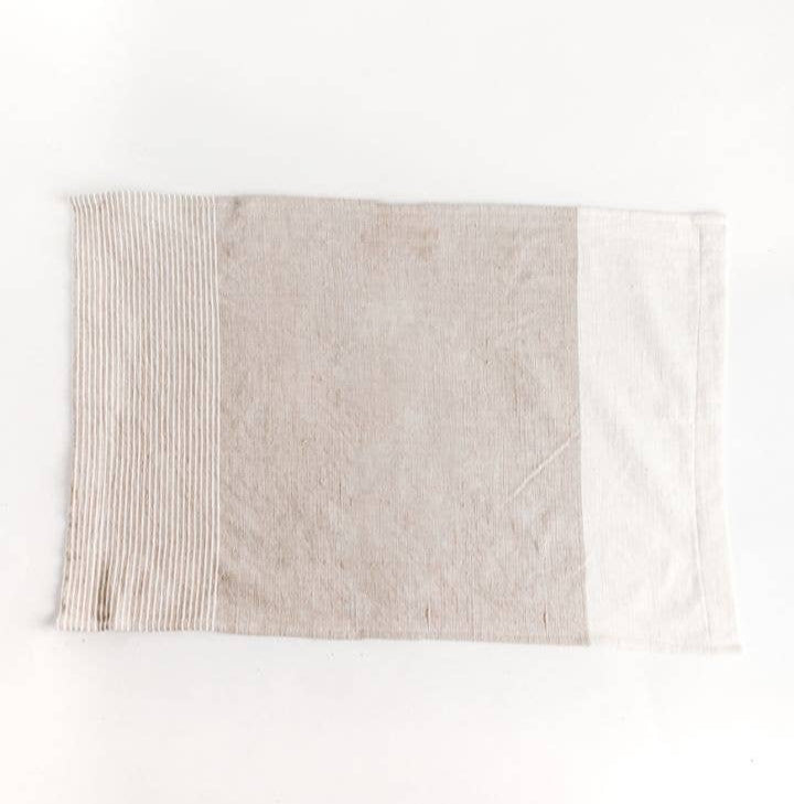 A color blocked tea towel, in beige and white. 