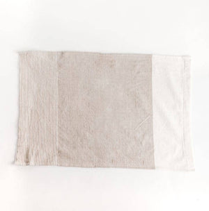 A color blocked tea towel, in beige and white. 