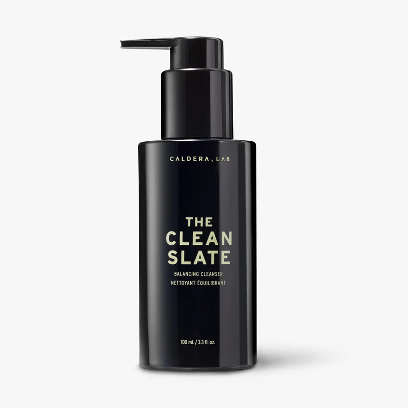 A black pump bottle labeled 'the clean slate' from Caldera + Lab, classified as a 'Night Cleaner' on the packaging.