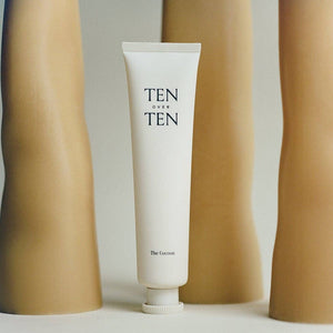 White tube labeled 'TEN over TEN' with beige cylindrical products on a light background