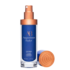 Augustinus Bader the cream with blue packaging and bronze cap on a white background