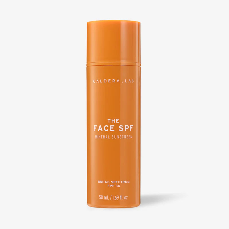 A cylindrical orange bottle of Caldera + Lab The Face SPF mineral sunscreen with SPF 30, indicating broad spectrum protection.