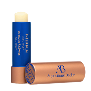 A tube of Augustinus Beer The Lip Balm with a copper top