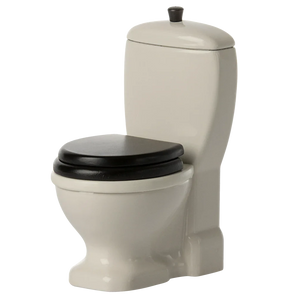 Beige toilet with black seat on a white background