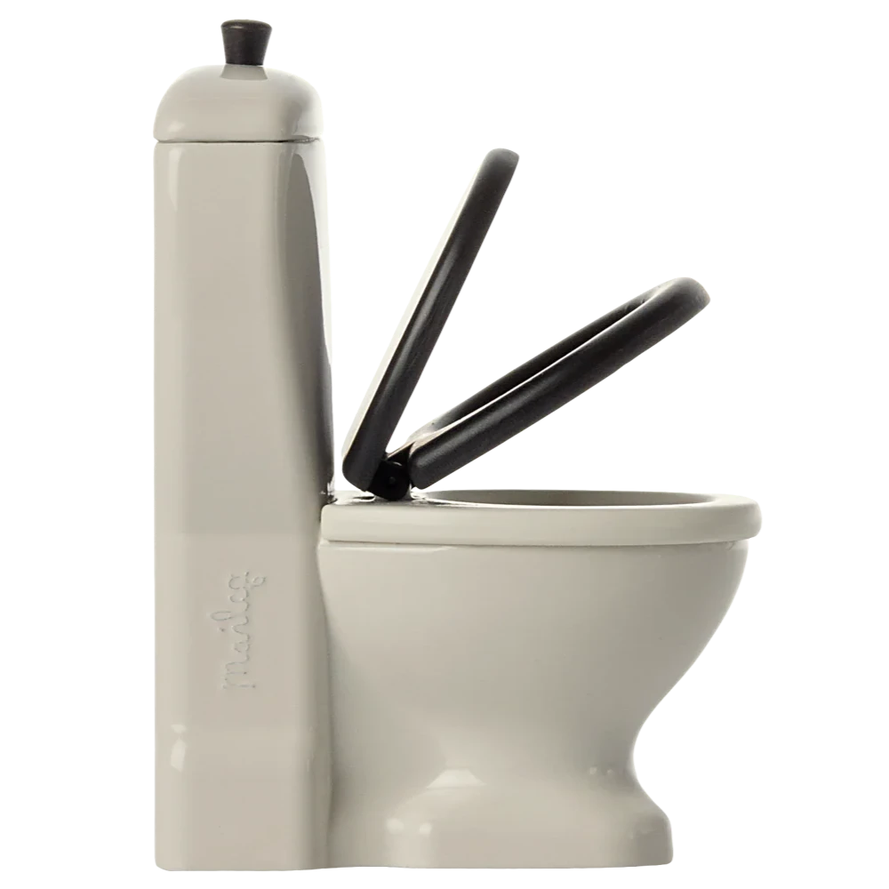 Beige toilet with black seat on a white background
