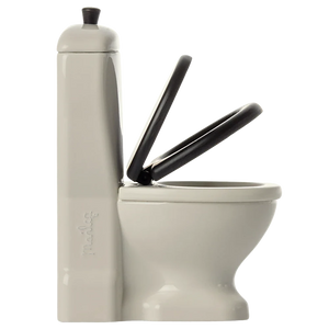 White toilet with black seat and lid on a plain background