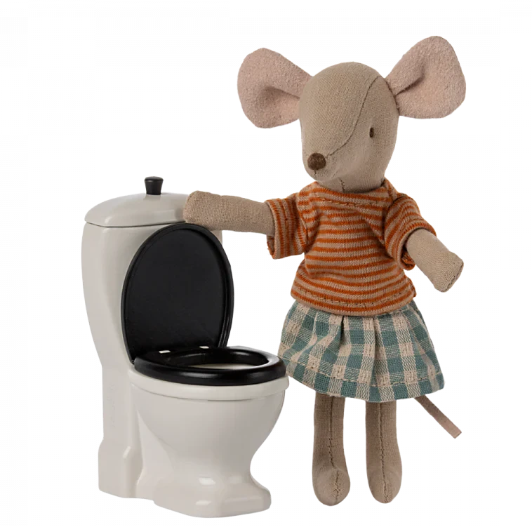 Stuffed mouse toy in striped shirt and skirt next to a small white toilet.