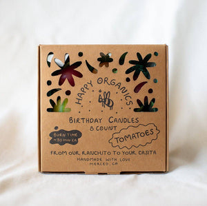 Cardboard box with 'Happy Organics' branding on a white background