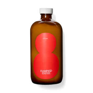 Flamingo Estate tomato lotion, in a brown glass bottle with a white top