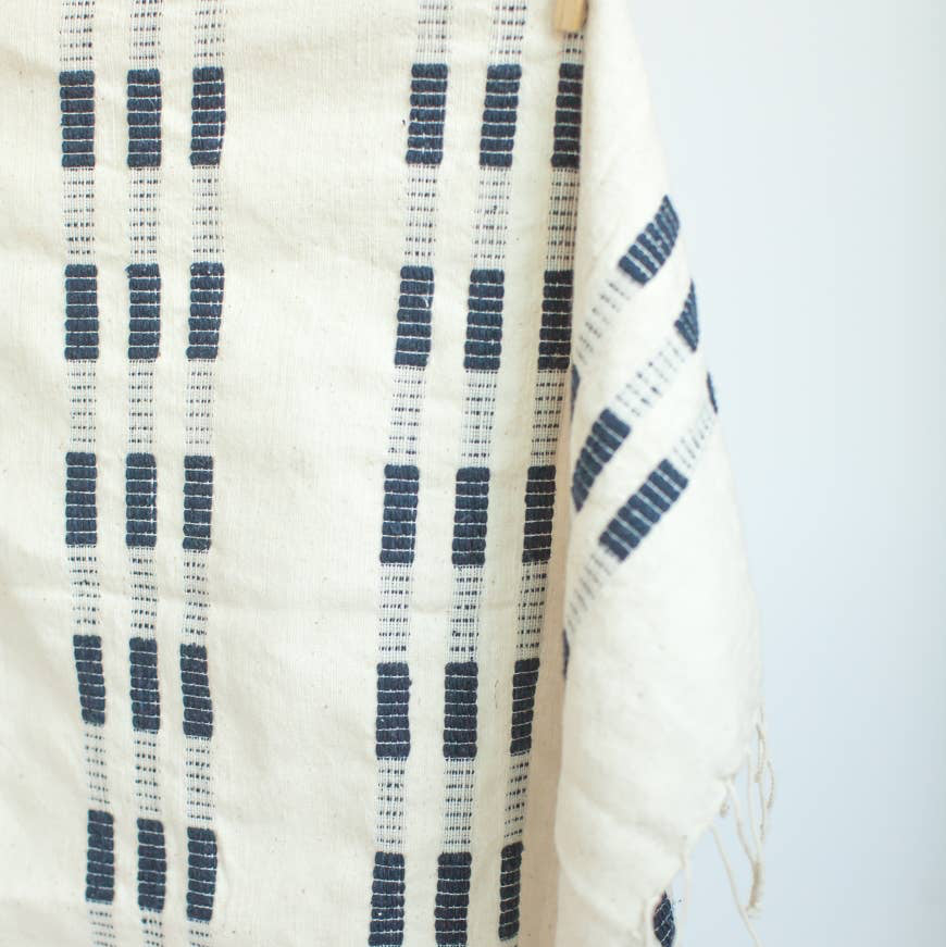 A blue and white tea towel with a clothespin.