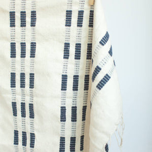 A blue and white tea towel with a clothespin.