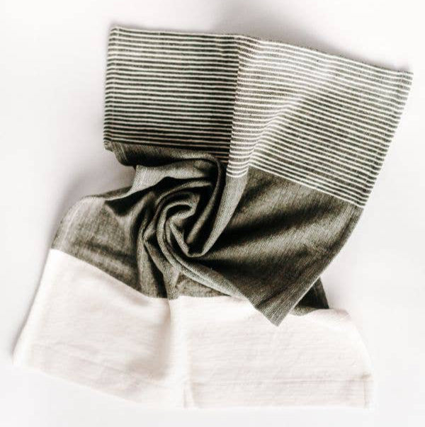 A folded Chesapeake tea towel featuring natural and accented colors with textured stripes, displayed on a white background.
