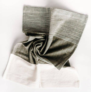A folded Chesapeake tea towel featuring natural and accented colors with textured stripes, displayed on a white background.