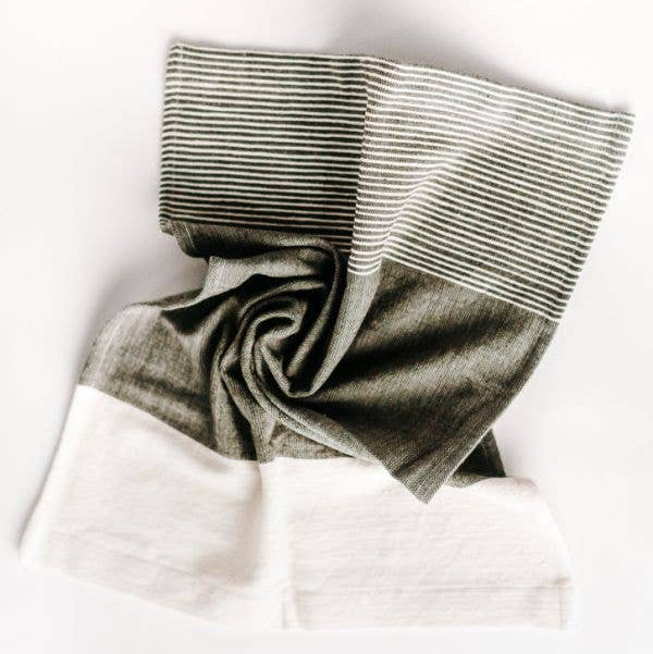 A folded Chesapeake tea towel featuring natural and accented colors with textured stripes, displayed on a white background.