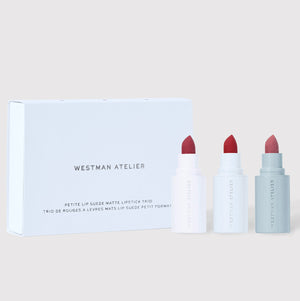 Westman Atelier lipstick set with three lipsticks and a box on a light background