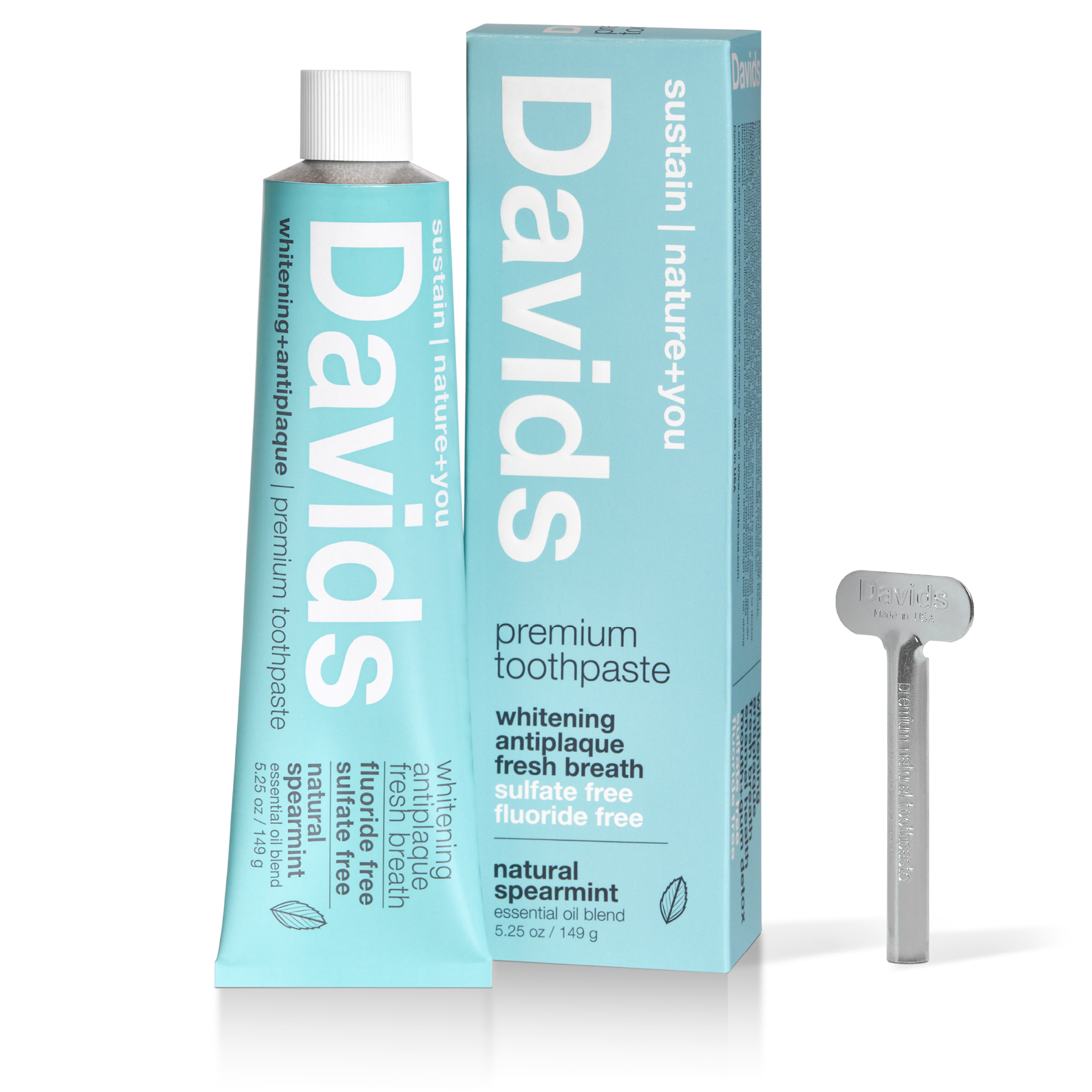 A tube of David's spearmint toothpaste next to the box and tube key.
