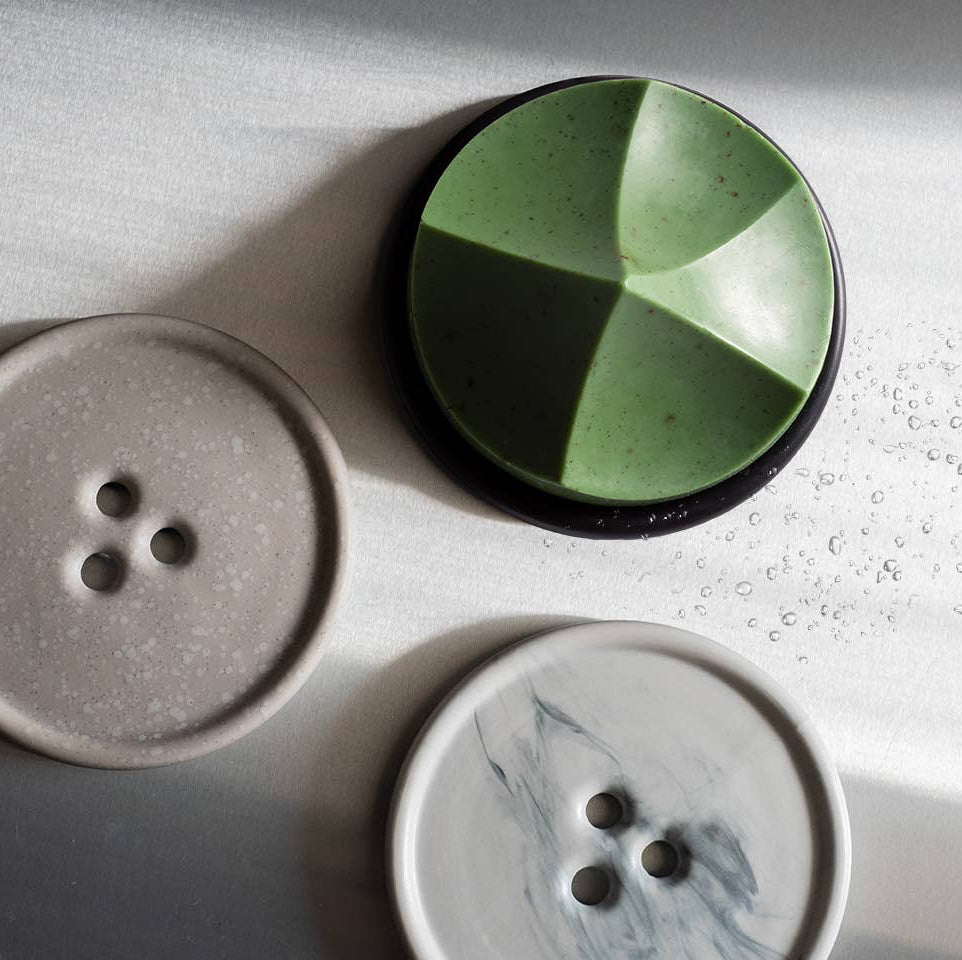 A green ume studios soap on a black bouton. 