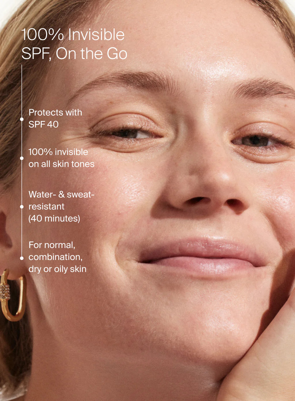 Woman's face with skincare product application, text about SPF 40 protection.