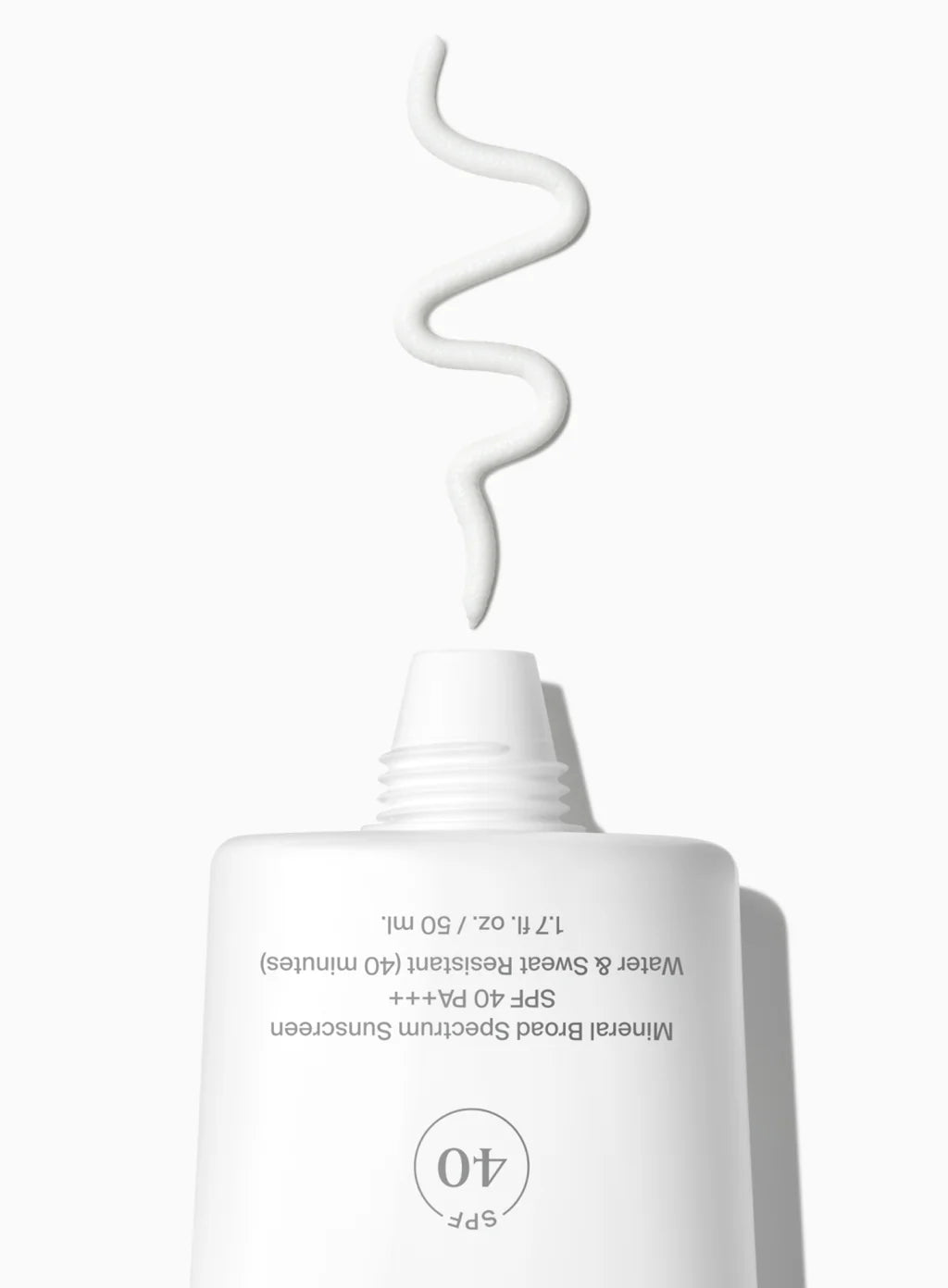 White skincare product with a spray nozzle on a white background