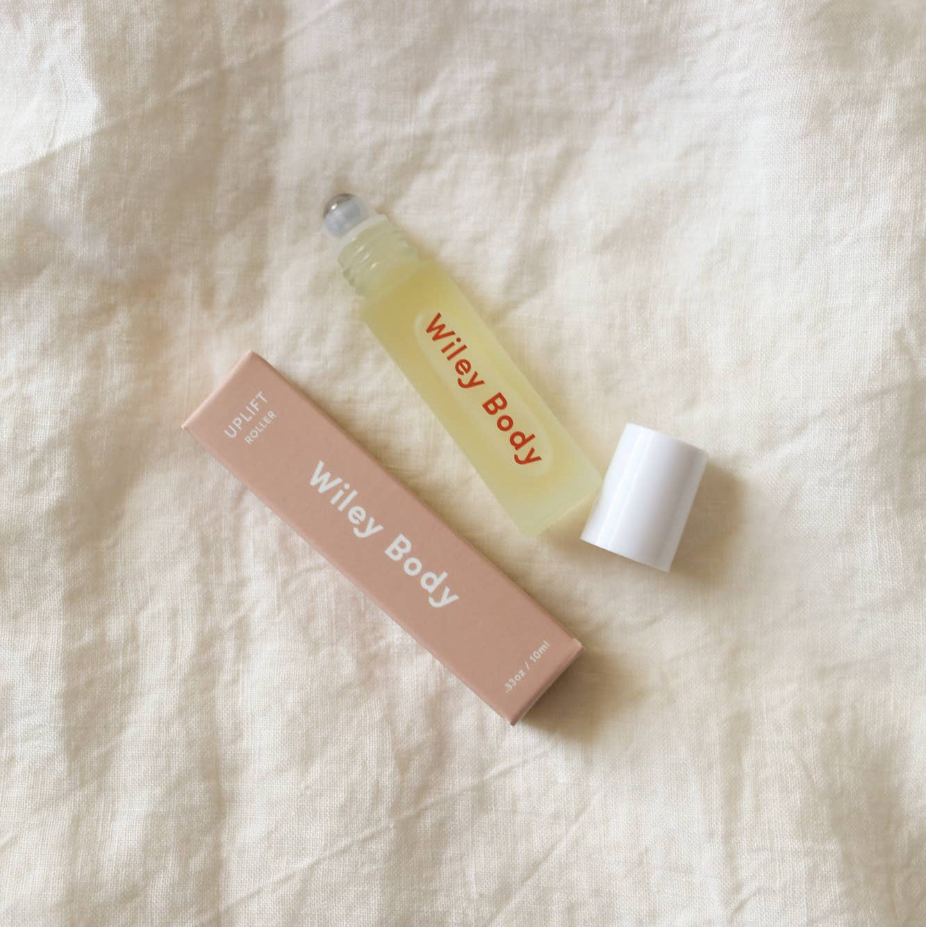 A Wiley body uplift roller on cream colored fabric. 