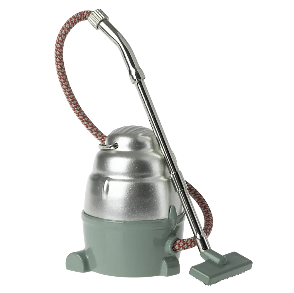 Small metal and green device with a hose on a white background