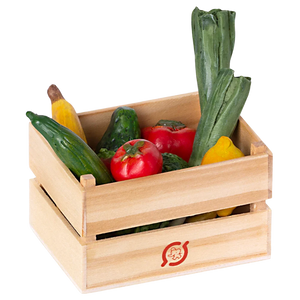 A wooden crate filled with miniature play fruits and vegetables, including carrots, cucumbers, and tomatoes.