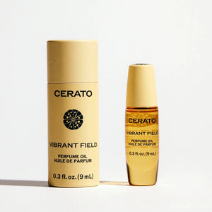 Two gold bottles of Cerato Vibrant Field perfume oil on a white background