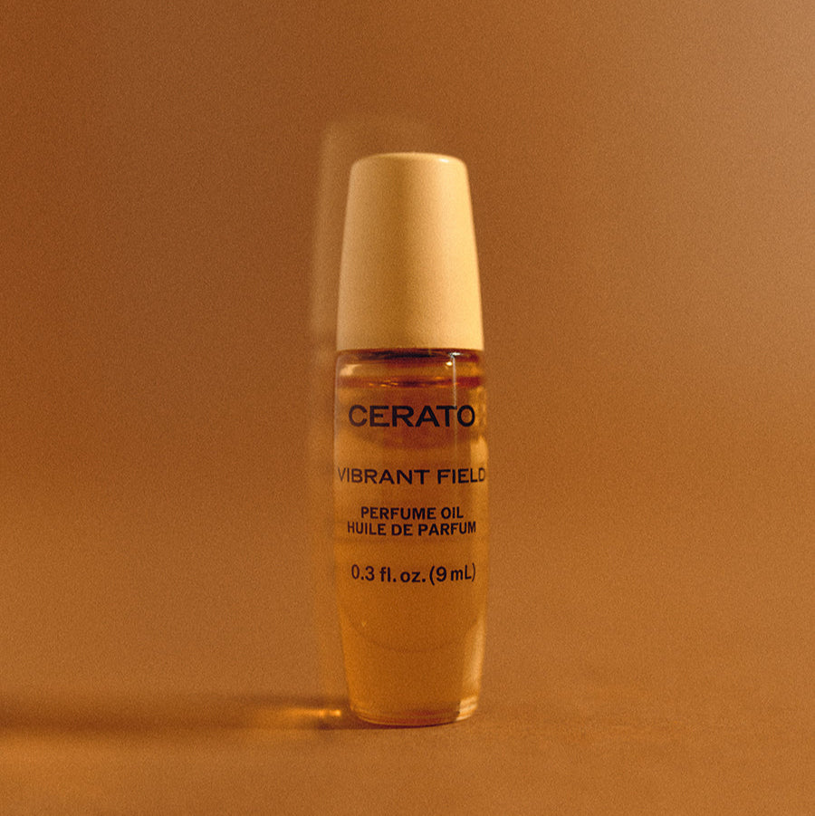 Two gold bottles of Cerato Vibrant Field perfume oil on a white background
