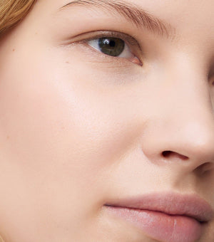 Close-up of a person's eye and nose with a blurred background