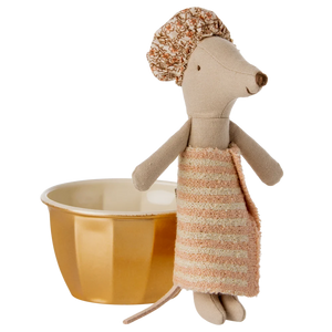 Toy mouse with a striped dress and hat next to a yellow bowl on a white background