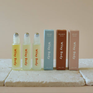 The Wiley Body essential oil rollers with their boxes. 