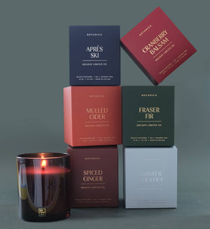 Collection of Botanica candles and boxes on a gray background