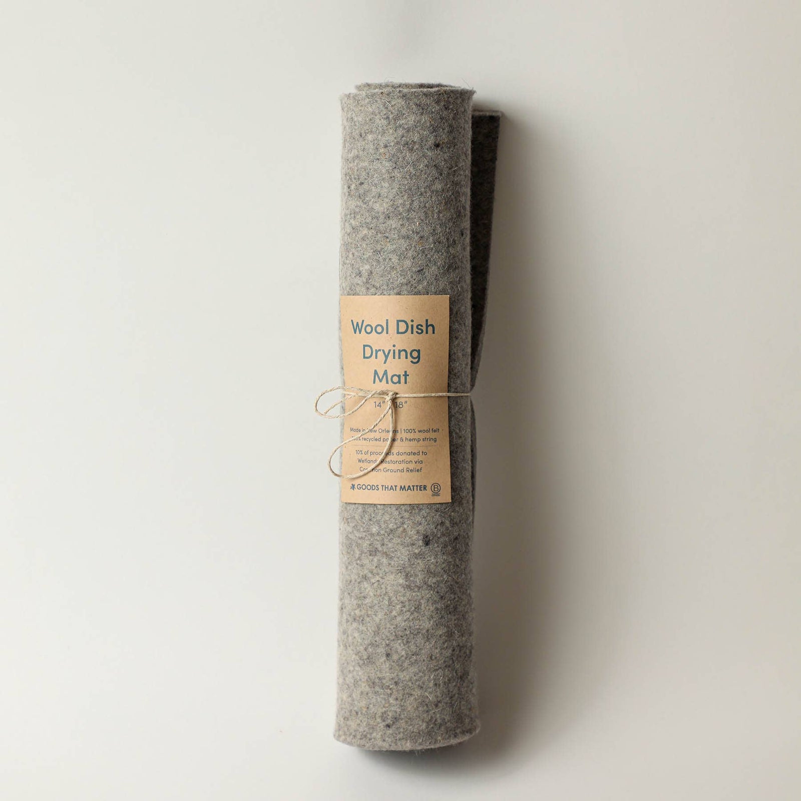 Three rolled-up dish drying mats with labels, set against a light background.