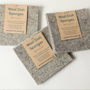 Three wool dish sponges on a light background. 